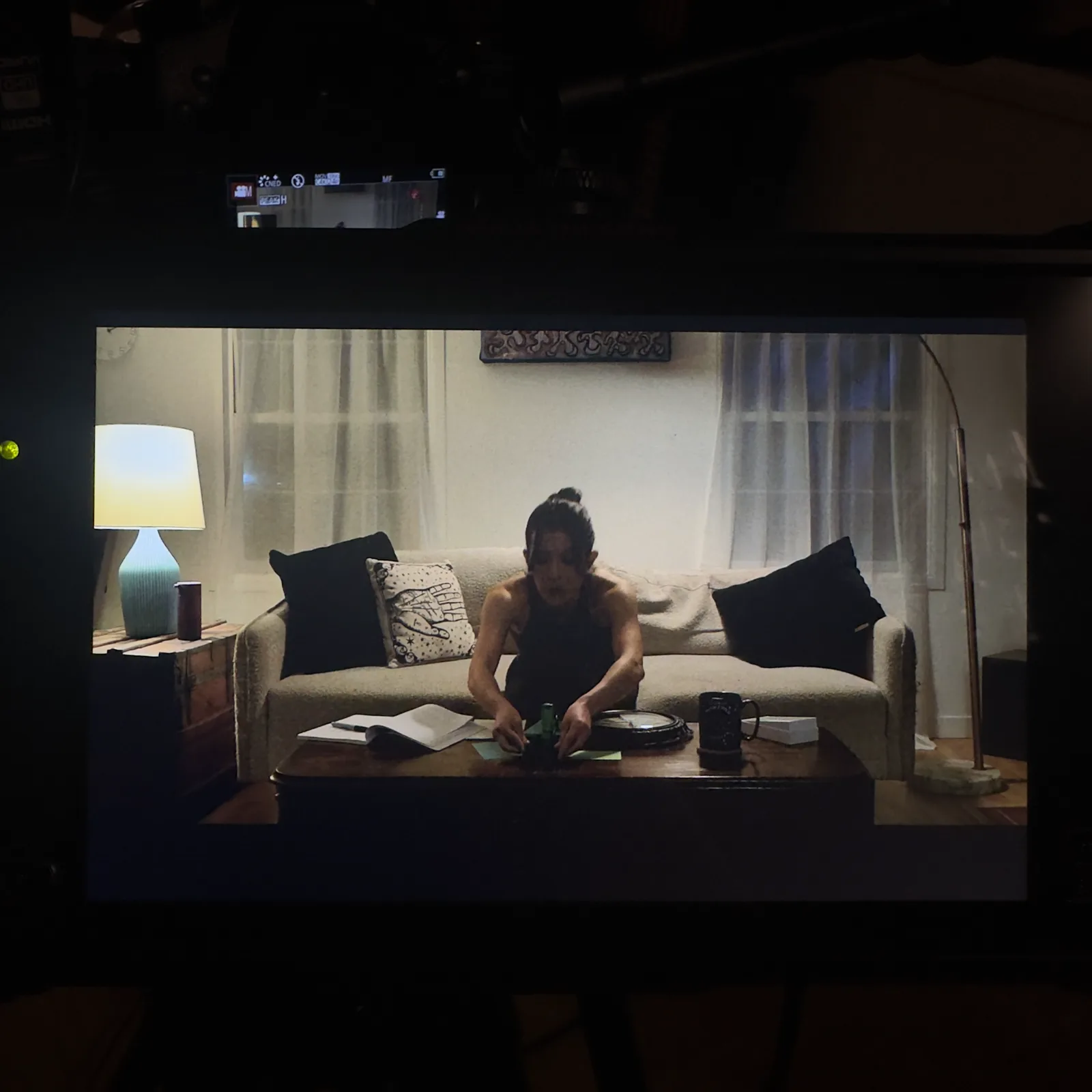 Kelly Lou Dennis as Toni on the couch, seen on the camera monitor