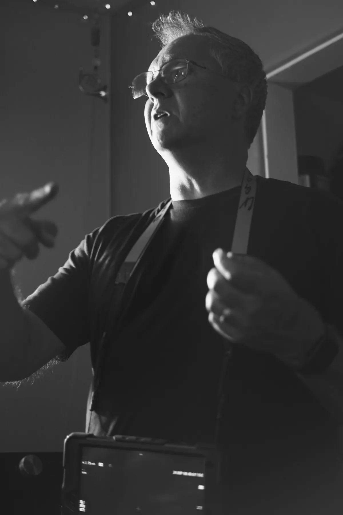 Black-and-white portrait holding a small mirror